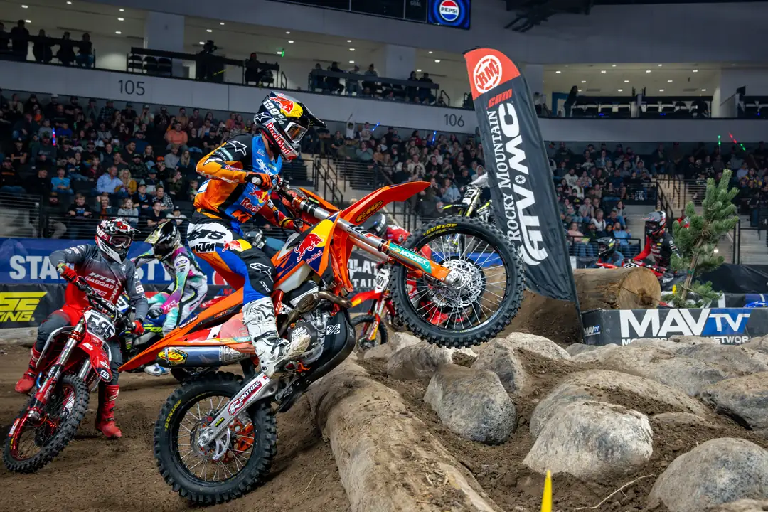 Rider hopping the log matrix in front of the crowd