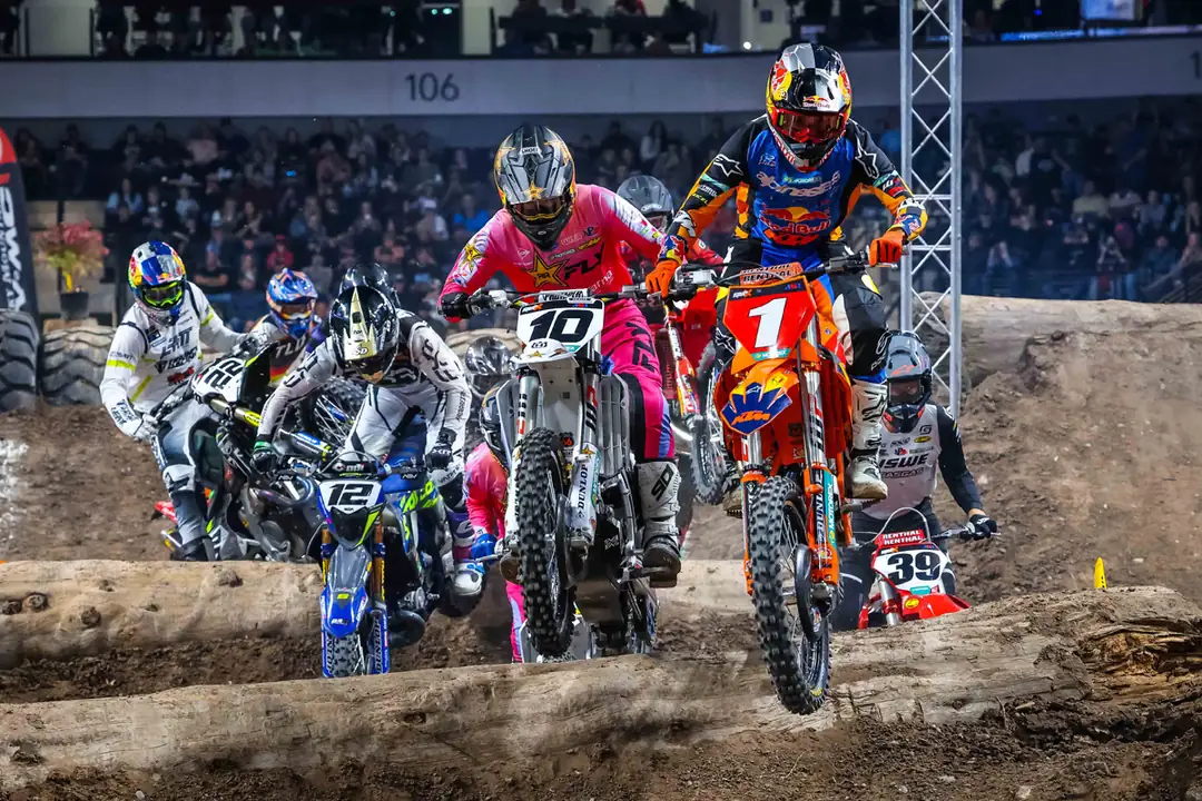 Riders three wide fighting over the rocks