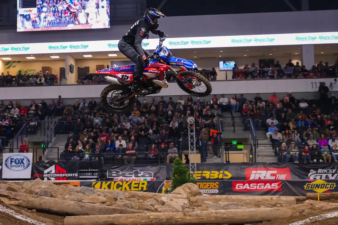 Rider throwing a whip high over the arena crowd