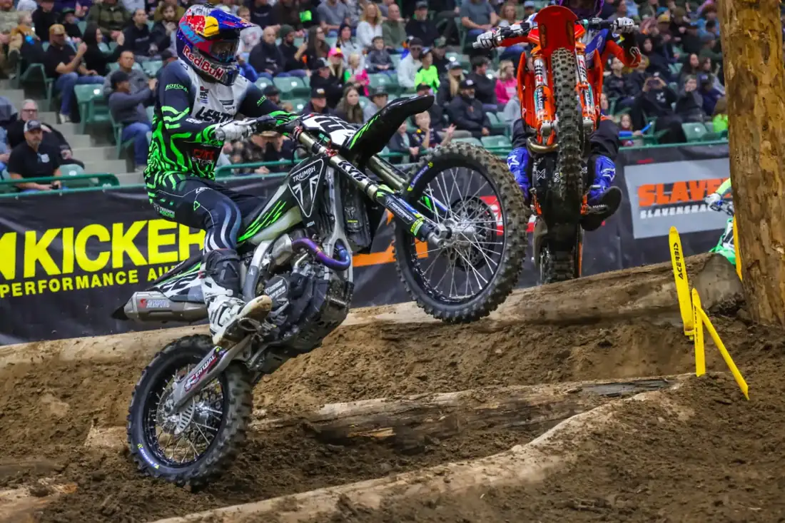 Rider clearing the log matrix obstacle at an EnduroCross indoor arena round
